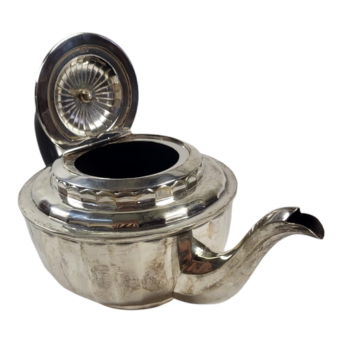 180 - A 20TH CENTURY SILVER TEAPOT
Having carved ebonised wooden finial and handle and flutes to body, hal... 