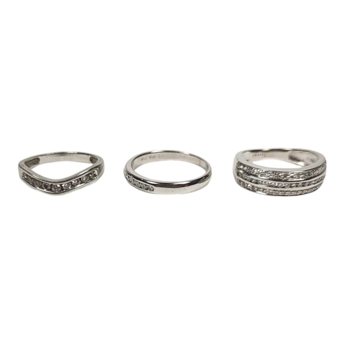 23 - A COLLECTION OF THREE 18ct WHITE GOLD AND DIAMOND RINGS,to include a three row diamond ring and two ... 