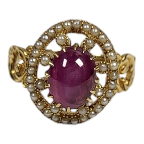 29 - A YELLOW METAL, STAR RUBY AND SEED PEARL RING
The cabochon cut ruby edged with seed pearls in a pier... 