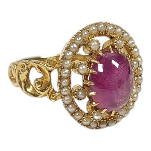 29 - A YELLOW METAL, STAR RUBY AND SEED PEARL RING
The cabochon cut ruby edged with seed pearls in a pier... 