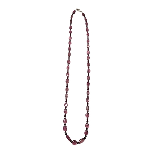 34 - A PINK TOURMALINE AND RUBY NECKLACE
Oval cut tourmaline with ruby bead links, on silver clasp.
(appr... 