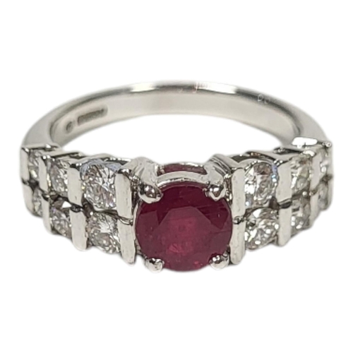 35 - AN 18CT WHITE GOLD, RUBY AND DIAMOND RING
Set with a single round cut ruby with two rows of graduate... 