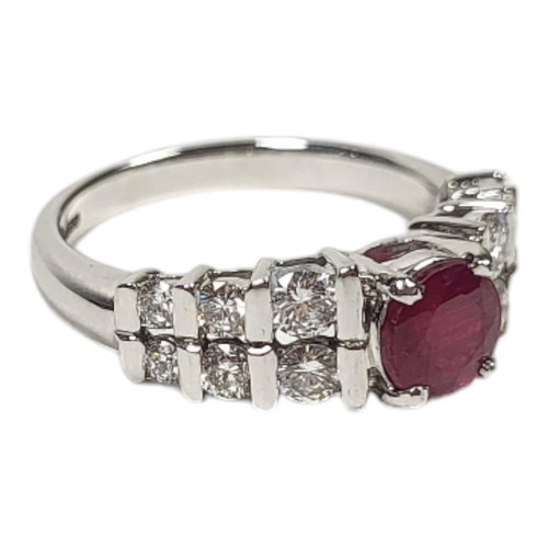 35 - AN 18CT WHITE GOLD, RUBY AND DIAMOND RING
Set with a single round cut ruby with two rows of graduate... 