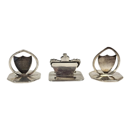 43 - A COLLECTION OF THREE EARLY 20TH CENTURY SILVER MENU HOLDERS
Two of shield form and one coronet, to ... 