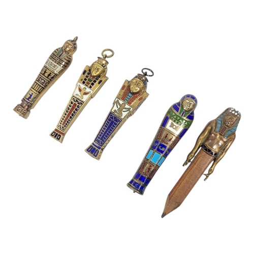 51 - A COLLECTION OF FOUR EARLY 20TH CENTURY YELLOW METAL AND ENAMEL ‘EGYPTIAN REVIVAL’ PROPELLING PENCIL... 