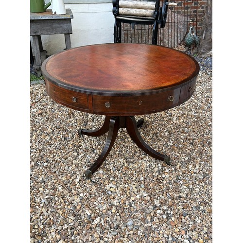 586 - A GEORGE III MAHOGANY RENT/DRUM TABLE
The circular top with tan and gilt tooled leather surface abov... 