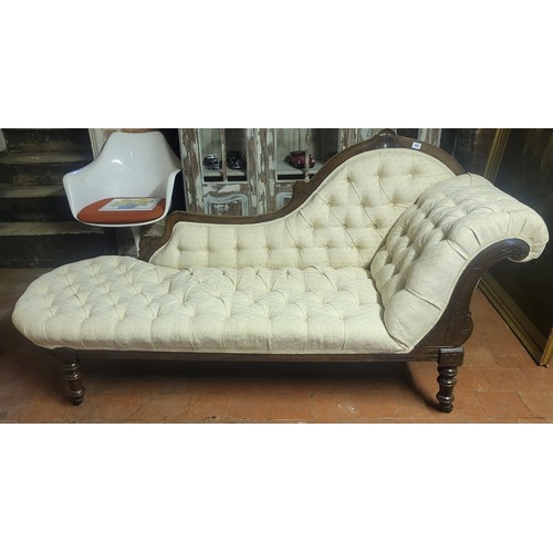 583 - A VICTORIAN MAHOGANY CHAISE LOUNGE
With cream button back fabric upholstery, raised on turned legs o... 