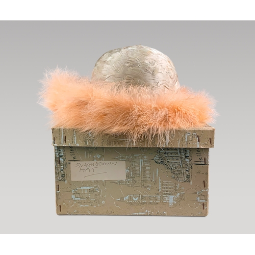 135A - A 20TH CENTURY HARRODS PEACH 'SWANSDOWN’ FEATHERED HAT.

With original box.

(h 15cm x w 28cm x d 28... 