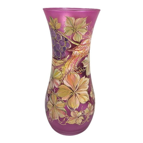 704 - WITHDRAWN A 20TH CENTURY CONTINENTAL CRANBERRY GLASS VASE
Hand painted with an exotic bird and flora... 