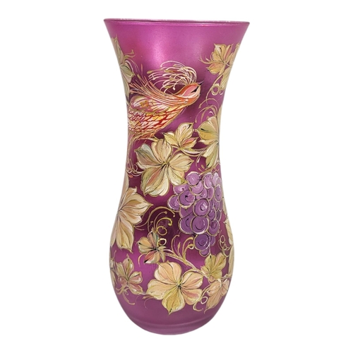 704 - WITHDRAWN A 20TH CENTURY CONTINENTAL CRANBERRY GLASS VASE
Hand painted with an exotic bird and flora... 