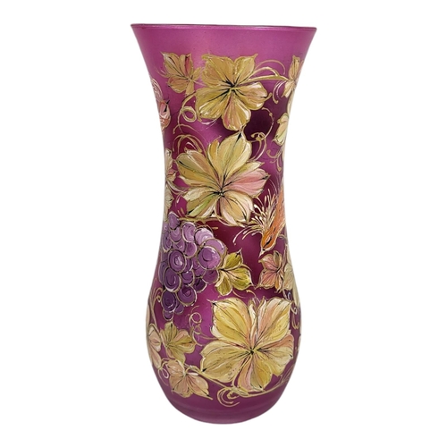 704 - WITHDRAWN A 20TH CENTURY CONTINENTAL CRANBERRY GLASS VASE
Hand painted with an exotic bird and flora... 