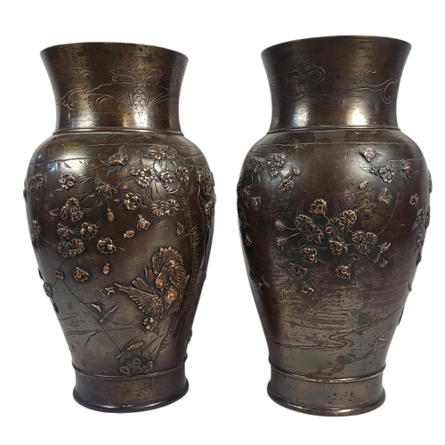 706 - A PAIR OF 19TH CENTURY JAPANESE BRONZE VASES
Baluster form, with applied declaration of birds and fl... 