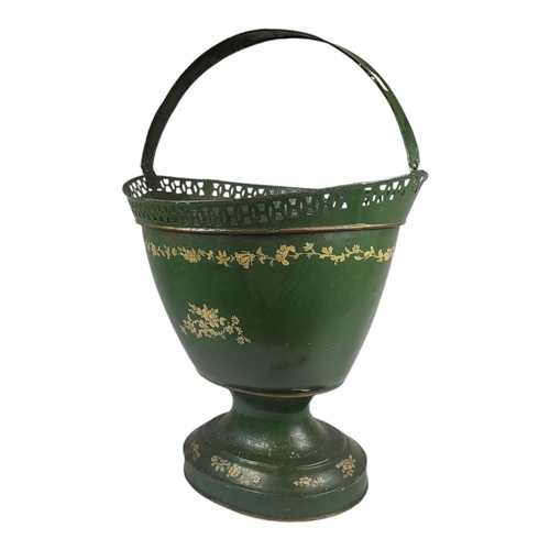 712 - A 19TH CENTURY TOLEWARE BASKET
The single carry handle with hand painted floral decoration on green ... 