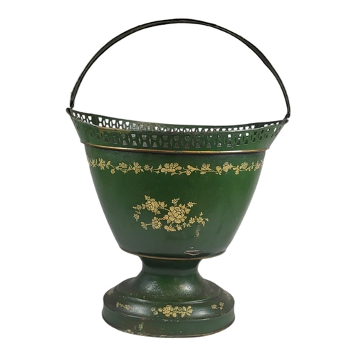 712 - A 19TH CENTURY TOLEWARE BASKET
The single carry handle with hand painted floral decoration on green ... 