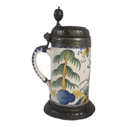 713 - A LARGE 18TH CENTURY GERMAN FAIENCE POTTERY AND PEWTER BEER STEIN
Having an acorn finial to lid,hand... 