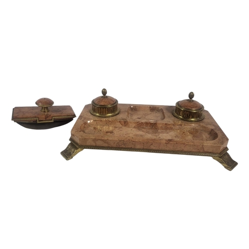 714 - A LARGE EARLY 20TH CENTURY GILT BRASS AND ROUGE MARBLE INKSTAND
A pair of lidded circular inkwells o... 