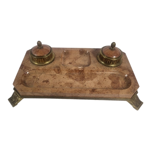 714 - A LARGE EARLY 20TH CENTURY GILT BRASS AND ROUGE MARBLE INKSTAND
A pair of lidded circular inkwells o... 