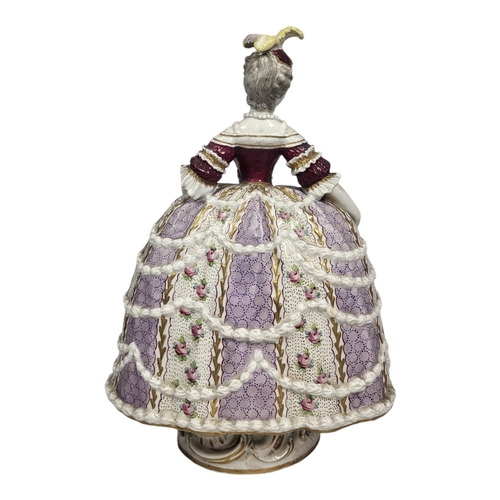 718 - A 19TH CENTURY CONTINENTAL PORCELAIN FIGURE OF LADY WITH FAN
Wearing an elaborate ballroom gown of 1... 