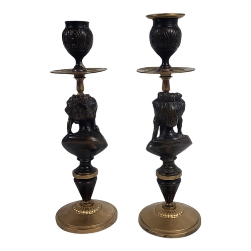 737 - A PAIR OF 19TH CENTURY BRONZE AND ORMOLU FIGURAL CANDLESTICKS
Empire design, having urn form finials... 