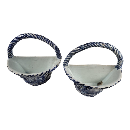 756 - A PAIR OF EARLY 20TH CENTURY BLUE AND WHITE DELFTWARE POTTERY WALL POCKETS/BASKETS
Having a single c... 