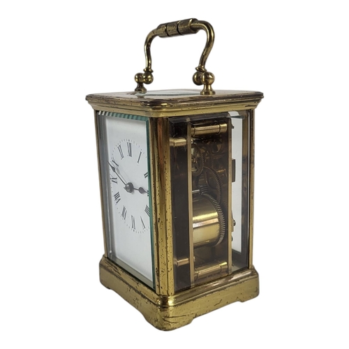 799 - A 20TH CENTURY FRENCH GILT BRASS CARRIAGE CLOCK
Having a single carry handle and four bevelled glass... 