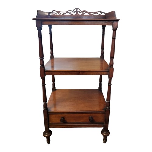 986 - A VICTORIAN MAHOGANY WHATNOT
Having a pierced gallery, on turned supports, two shelves and drawer to... 