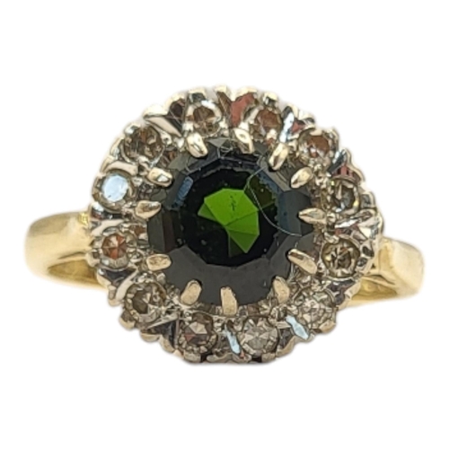 37 - A VINTAGE 18CT GOLD, GREEN TOURMALINE AND DIAMOND
The round cut stone edged with diamonds, in a velv... 