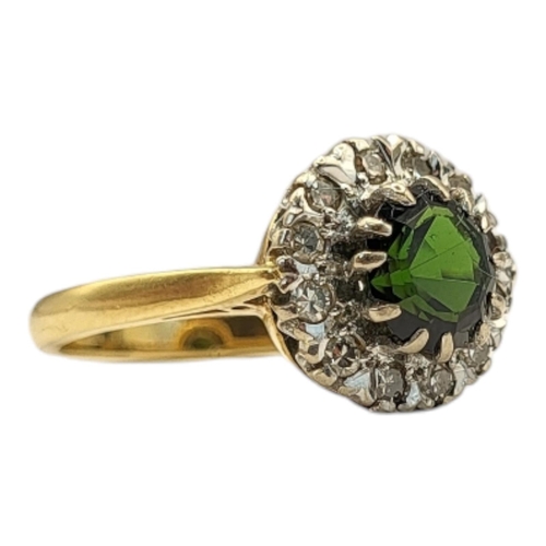 37 - A VINTAGE 18CT GOLD, GREEN TOURMALINE AND DIAMOND
The round cut stone edged with diamonds, in a velv... 