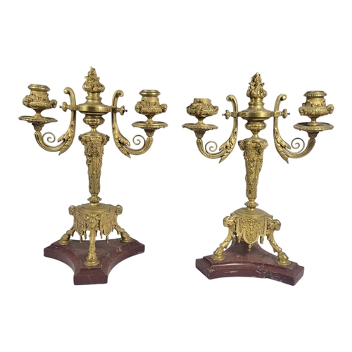 186 - A PAIR OF 19TH CENTURY GILT BRONZE AND MARBLE CANDELABRA
Twin branch arms with rams head motifs with... 