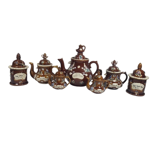 185 - A COLLECTION OF FIVE 20TH CENTURY POTTERY BARGE WARE TEAPOTS
Each having a miniature teapot finial a... 