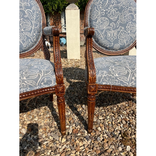 443 - A PAIR OF LATE 19TH CENTURY FRENCH CARVED WALNUT SPOONBACK OPEN ARMCHAIRS
In pale blue floral uphols... 