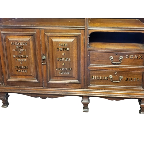 449 - A LATE 19TH CENTURY MAHOGANY SCOTTISH KILT SHOPS DISPLAY CABINET, SIGN WRITTEN
The central open shel... 