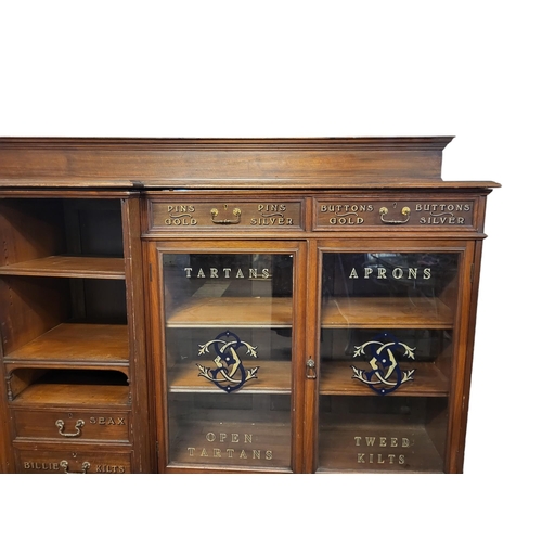 449 - A LATE 19TH CENTURY MAHOGANY SCOTTISH KILT SHOPS DISPLAY CABINET, SIGN WRITTEN
The central open shel... 