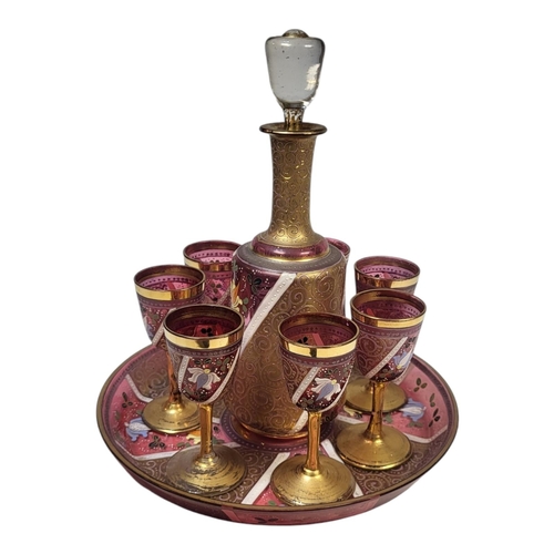 113A - A FINE BOHEMIAN PINK FLASHED GLASS JEWELLED OVERLAID LIQUER DRINKING SET FOR SIX, CIRCA 1900
Decorat... 