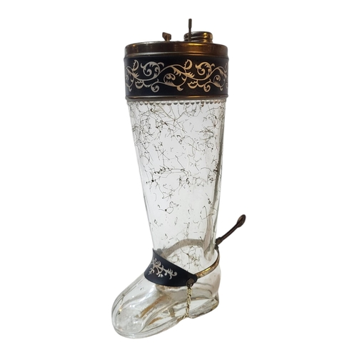 116 - AN EARLY 20TH CENTURY CONTINENTAL NOVELTY MUSICAL GLASS DECANTER MODELLED AS A RIDING BOOT, CIRCA 19... 