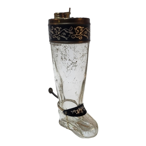 116 - AN EARLY 20TH CENTURY CONTINENTAL NOVELTY MUSICAL GLASS DECANTER MODELLED AS A RIDING BOOT, CIRCA 19... 