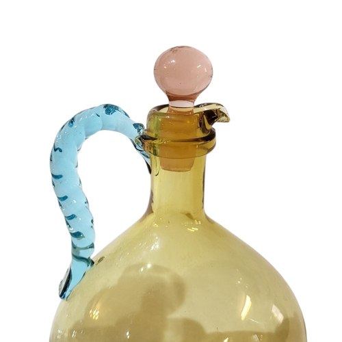 121 - AN EARLY 20TH CENTURY MURANO DECANTER AND STOPPER
With mounted pink flashed rim and base, having han... 