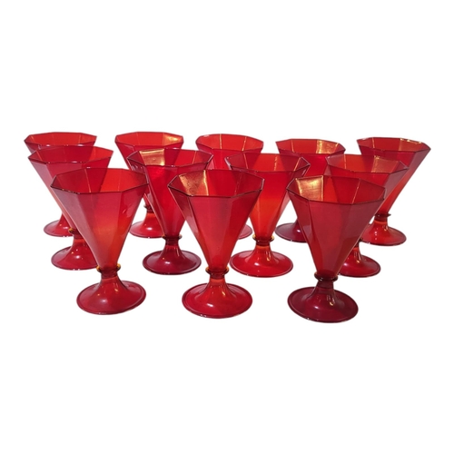 124 - A SET OF TWELVE MURANO ART DECO SHAPED CRANBERRY IRON RED RUMMERS/WINE GLASSES
With octagonal shaped... 