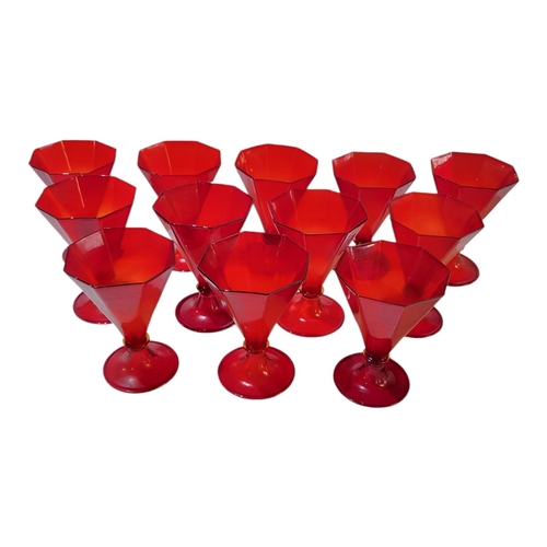 124 - A SET OF TWELVE MURANO ART DECO SHAPED CRANBERRY IRON RED RUMMERS/WINE GLASSES
With octagonal shaped... 