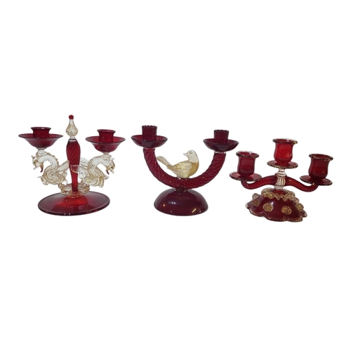 126 - TWO MURANO GLASS ART IRON RED GLAZED TWO LIGHT TABLE CANDELABRA 
Branches modelled with gilded drago... 