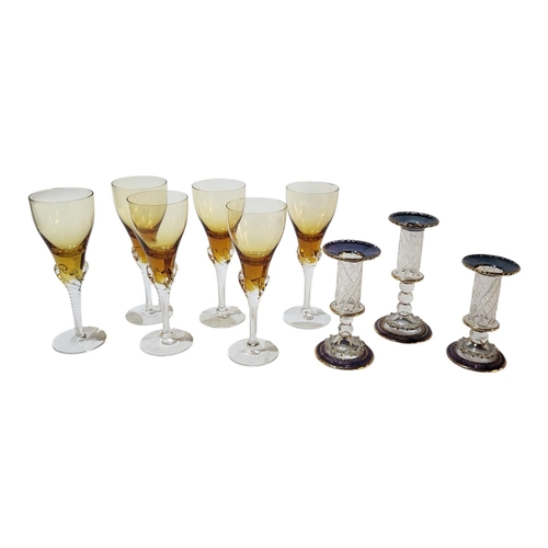 129 - A SET OF SIX EARLY 20TH CENTURY AMBER FLASHED SHERRY GLASSES 
Raised on twisted stems and conical fe... 