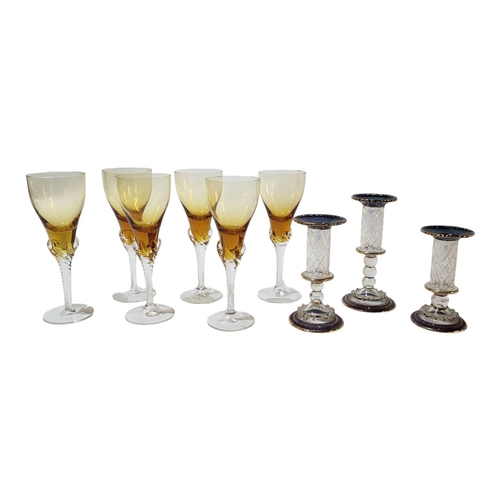 129 - A SET OF SIX EARLY 20TH CENTURY AMBER FLASHED SHERRY GLASSES 
Raised on twisted stems and conical fe... 