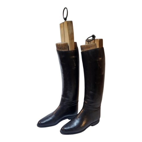 134 - A PAIR OF EARLY 20TH CENTURY LEATHER RIDING BOOTS
Complete with wooden boot trees, marked ‘Huntley a... 