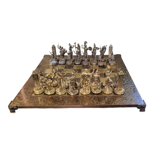 141 - MANOPOULOS, A 20TH CENTURY GREEK METALLIC CHESS SET
Modelled as Ancient Greek warriors, in gilt and ... 