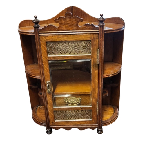 143 - A LATE VICTORIAN SOLID OAK SMOKER’S CABINET
The single bevelled glazed door with blind fretwork bras... 