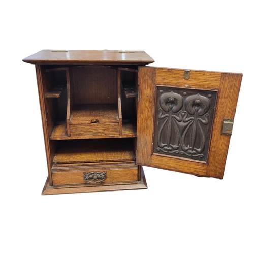 146 - A LATE VICTORIAN OAK SMOKER’S CABINET
With rise and fall top, single door inset with foil bird panel... 