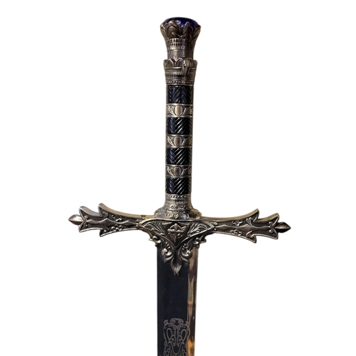 156 - A THEATRICAL POLISHED AND PATINATED STEEL SWORD
With faux sapphire inset pommel.
(119cm)