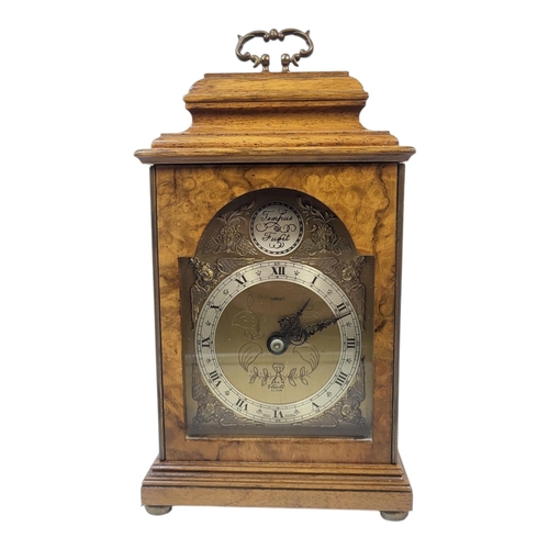 171 - A MID CENTURY WALNUT MANTEL CLOCK
The single brass handle, brass dial marked ‘Tempus Fugit Tarratt E... 