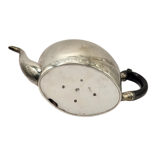 42 - A GEORGIAN SILVER OVAL TEAPOT
With ebonised wooden finial and handle and enrgraved decoration to bor... 