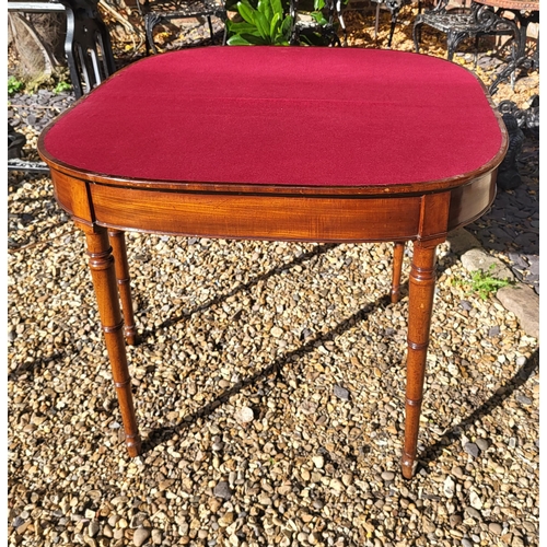 435 - A GEORGIAN MAHOGANY CARD TABLE
The demilune fold over top enclosing a blue baize playing surface, ra... 